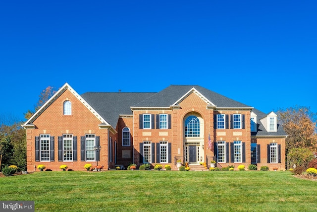 colonial inspired home with a front lawn