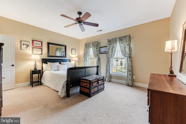 bedroom featuring light carpet and ceiling fan