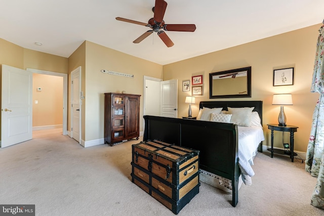 bedroom with ceiling fan and light carpet