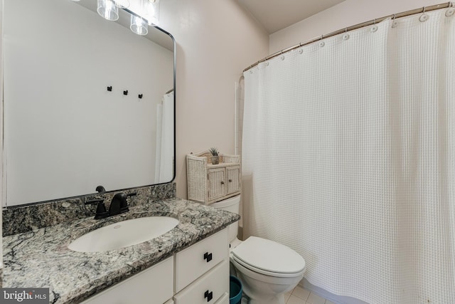 bathroom with vanity, tile patterned floors, and toilet