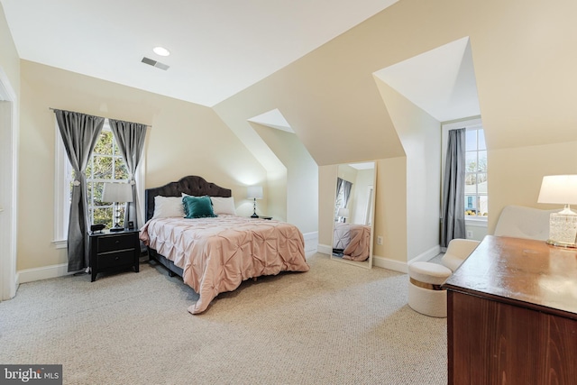 carpeted bedroom with lofted ceiling