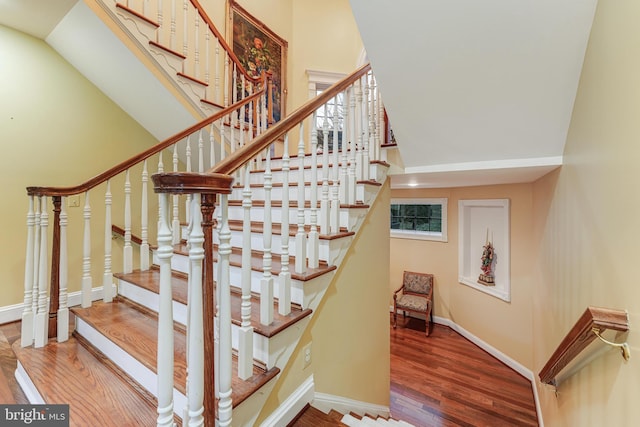 stairs featuring wood-type flooring