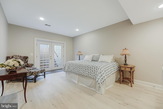 bedroom with access to outside, light wood-type flooring, and french doors