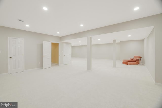 basement featuring light carpet