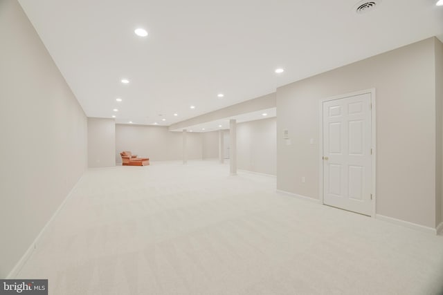 basement featuring light colored carpet