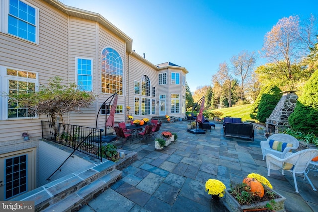 view of patio featuring an outdoor living space with a fireplace