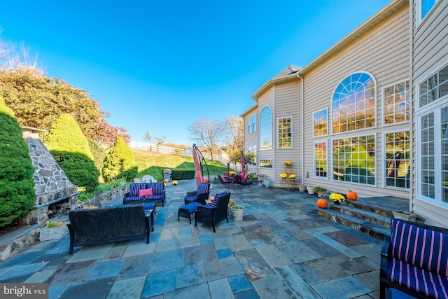 view of patio / terrace featuring an outdoor living space with a fireplace