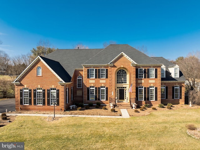 colonial inspired home with a front lawn