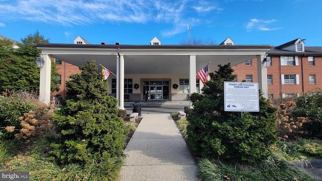 view of exterior entry with brick siding