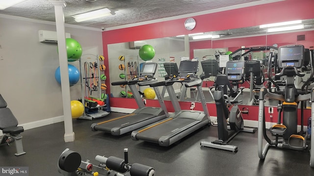 gym featuring ornamental molding, a textured ceiling, baseboards, and a wall mounted AC