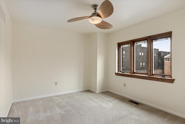 carpeted spare room with ceiling fan