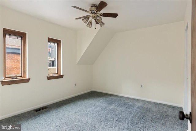 bonus room with ceiling fan and carpet