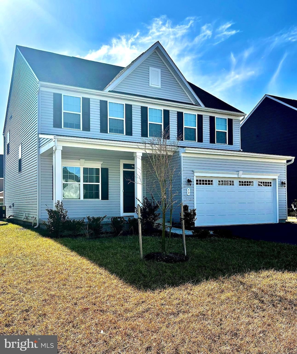 view of front property with a garage and a front yard