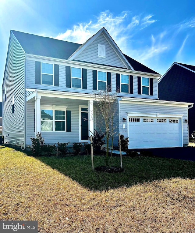 view of front property with a garage and a front yard