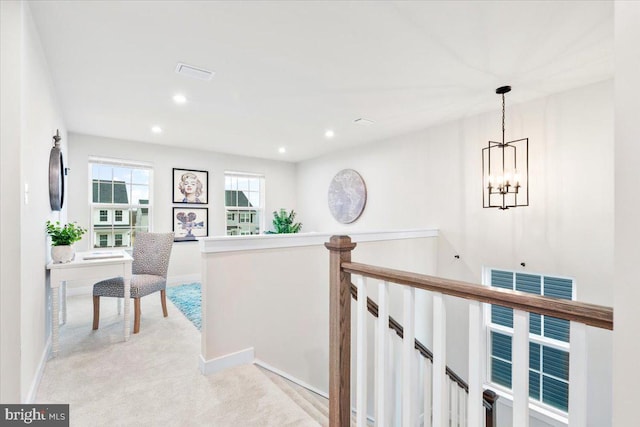 hall featuring recessed lighting, light carpet, visible vents, and an upstairs landing