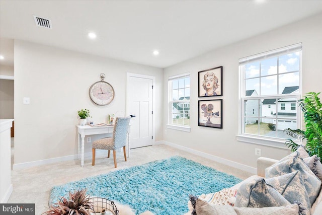 sitting room with light carpet, visible vents, baseboards, and recessed lighting