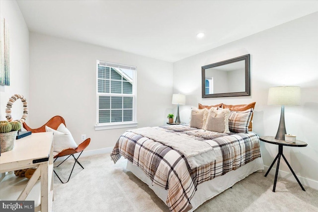 bedroom with light carpet and baseboards