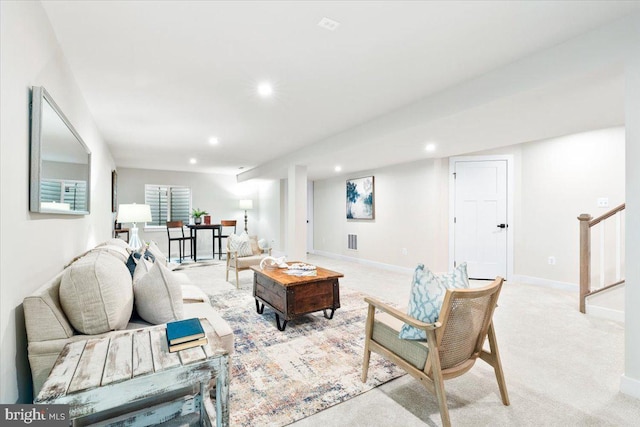 living area with stairs, baseboards, light colored carpet, and recessed lighting