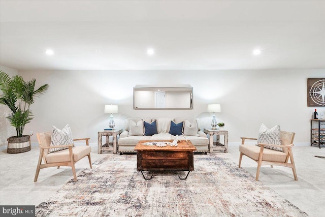 living room featuring recessed lighting, light colored carpet, and baseboards