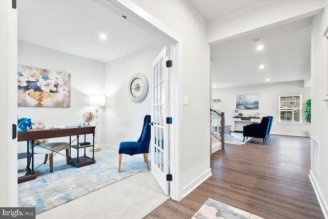 corridor featuring baseboards, visible vents, wood finished floors, and recessed lighting