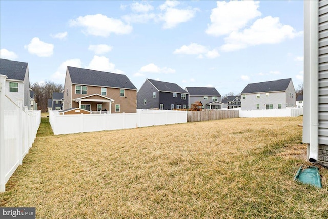 view of yard featuring a residential view and fence