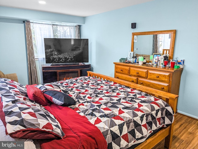 bedroom featuring multiple windows and hardwood / wood-style floors