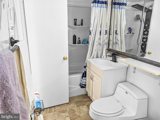 full bathroom featuring shower / bath combo, vanity, and toilet