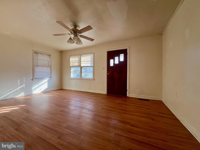 entryway featuring ceiling fan, ornamental molding, and dark hardwood / wood-style flooring