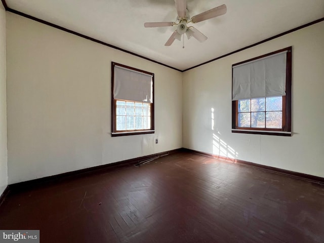 empty room featuring crown molding, dark hardwood / wood-style floors, and ceiling fan