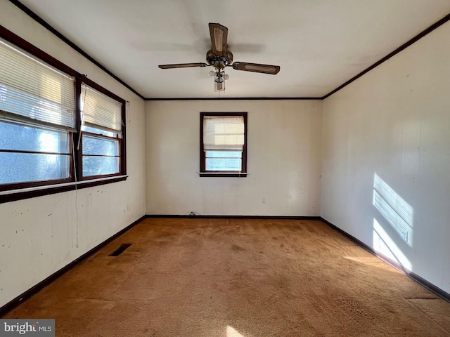 unfurnished room featuring crown molding, light carpet, and ceiling fan