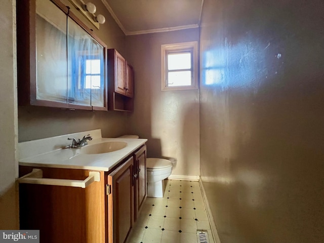 bathroom featuring crown molding, vanity, and toilet