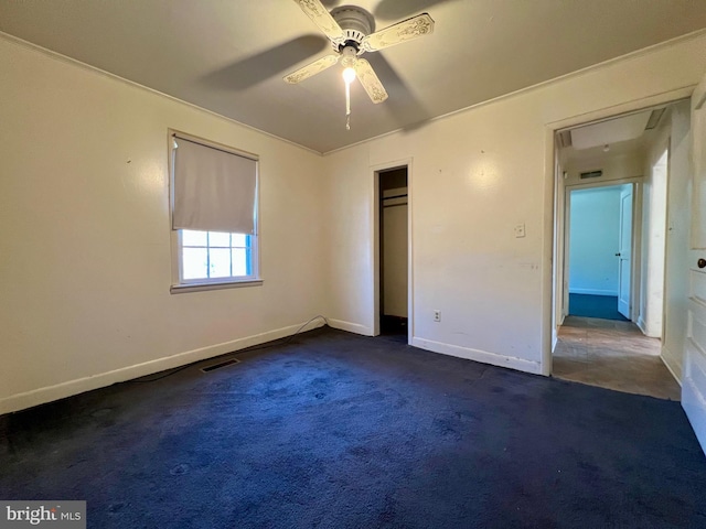 unfurnished bedroom featuring ceiling fan, a closet, and dark colored carpet