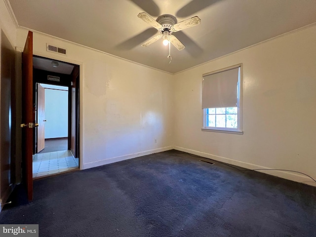 carpeted spare room with ceiling fan