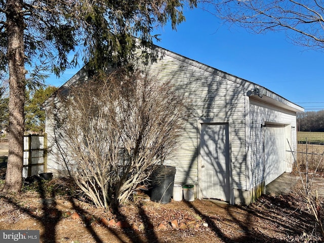 view of side of property featuring a garage and an outdoor structure