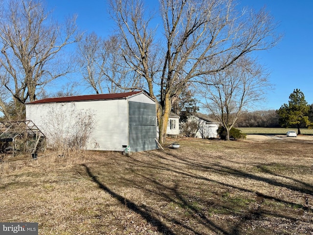 view of side of home featuring a lawn