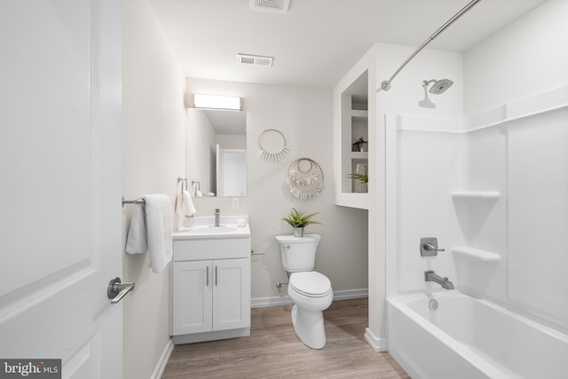 full bathroom featuring toilet, vanity, wood-type flooring, and  shower combination