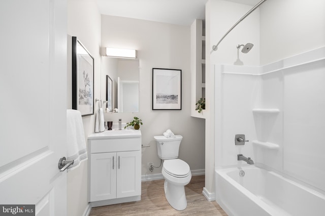 full bathroom featuring toilet, vanity, hardwood / wood-style floors, and shower / bathtub combination