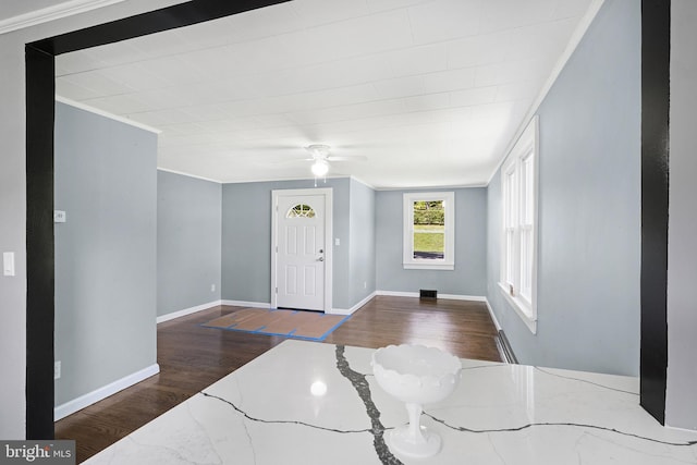 entrance foyer featuring wood-type flooring, ornamental molding, ceiling fan, and baseboard heating