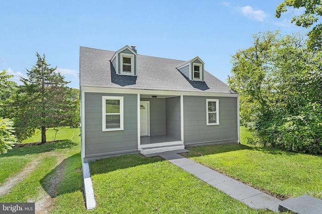 cape cod house with a front lawn