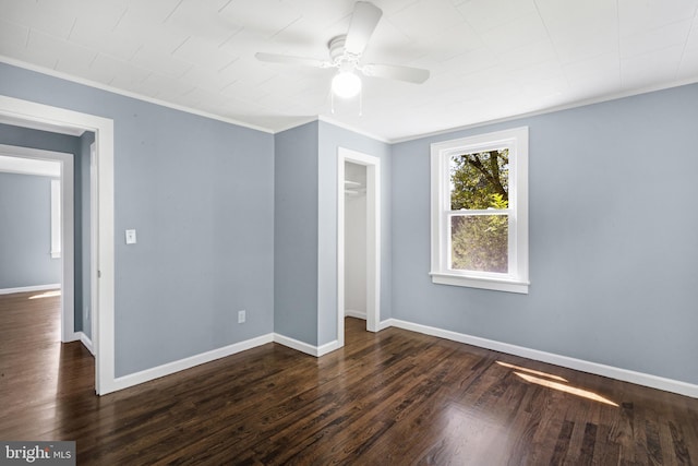 unfurnished bedroom featuring ornamental molding, dark hardwood / wood-style floors, ceiling fan, and a closet