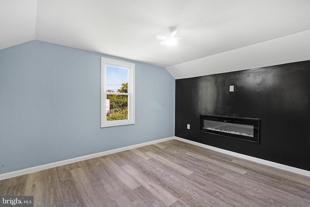 bonus room featuring lofted ceiling and light hardwood / wood-style flooring