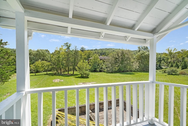 unfurnished sunroom with lofted ceiling with beams