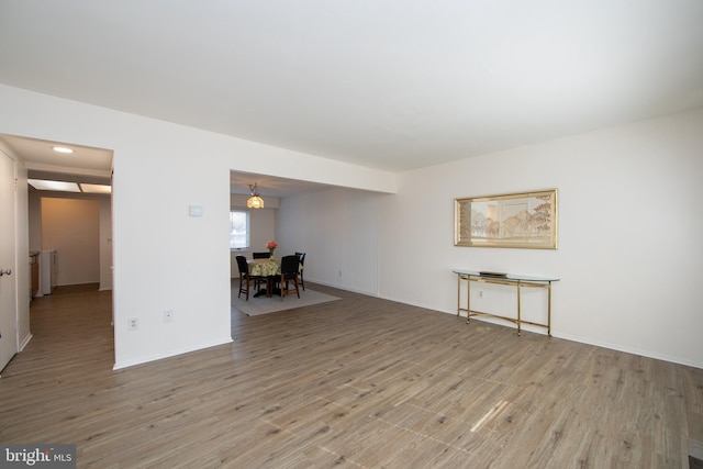 empty room with radiator heating unit and light wood-type flooring