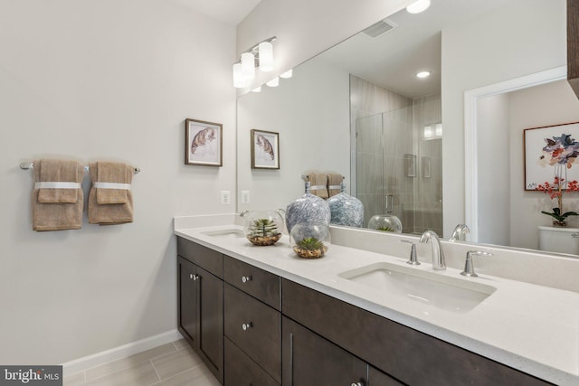 bathroom with a shower with door, vanity, and toilet