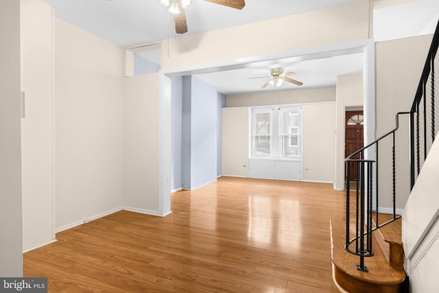 unfurnished living room featuring ceiling fan and light wood-type flooring