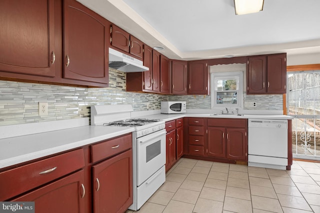 kitchen featuring white appliances, sink, light tile patterned floors, and backsplash