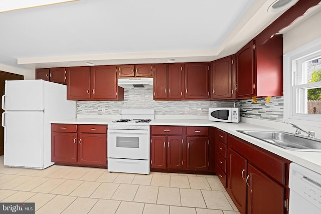 kitchen with white appliances, sink, and decorative backsplash