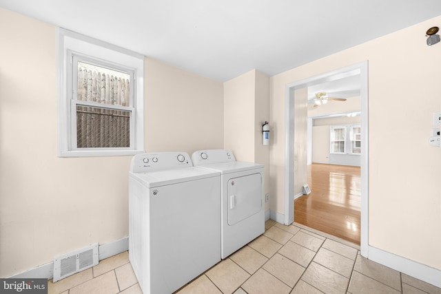 laundry room with light tile patterned flooring, ceiling fan, and washer and clothes dryer