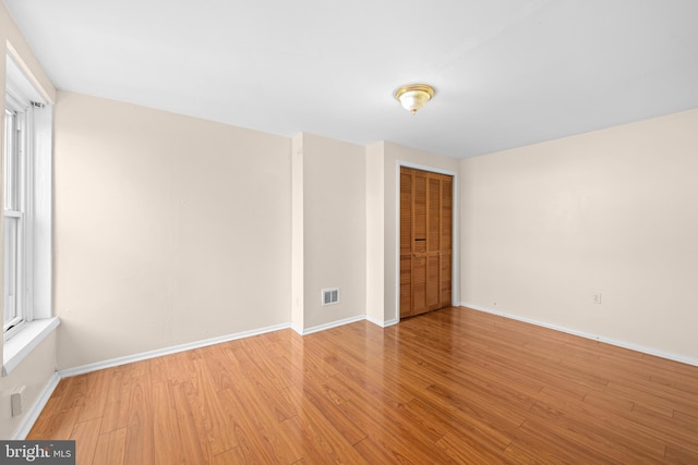 empty room with light hardwood / wood-style flooring