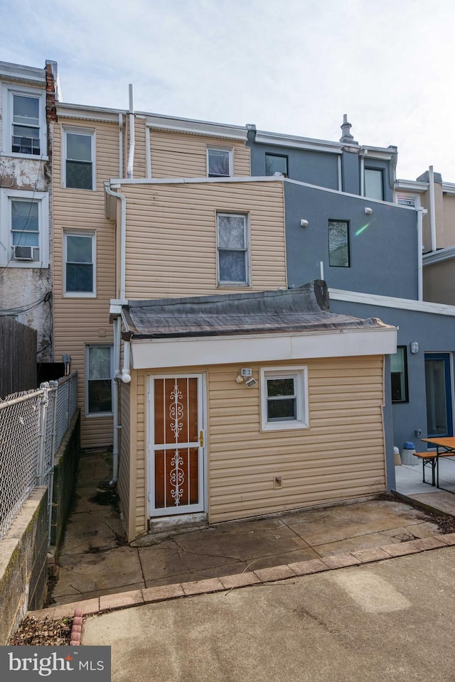 back of property with a patio